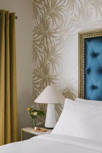 a bedroom with a bed and a wall with a painting at Beverly Terrace Hotel Beverly Hills, Sonder by Marriott Bonvoy in Los Angeles