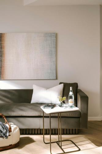 a living room with a couch and a table at La Ensenada Hotel Laguna Beach, Sonder by Marriott Bonvoy in Laguna Beach
