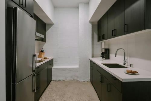 a kitchen with green cabinets and a refrigerator at Sonder by Marriott Bonvoy The Winfield Apartments Downtown LA in Los Angeles