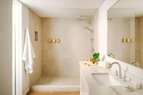 a bathroom with a sink and a shower at La Ensenada Hotel Laguna Beach, Sonder by Marriott Bonvoy in Laguna Beach