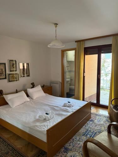 a bedroom with a large bed with towels on it at Villa Heritage - Old Town - PRIVATE GARAGE in Sarajevo
