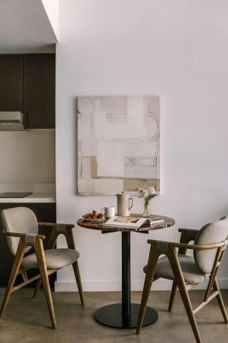 a table in a room with chairs and a painting at Sonder by Marriott Bonvoy The Winfield Apartments Downtown LA in Los Angeles