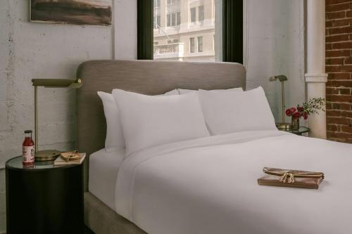 a white bed in a room with a window at Sonder by Marriott Bonvoy The Winfield Apartments Downtown LA in Los Angeles