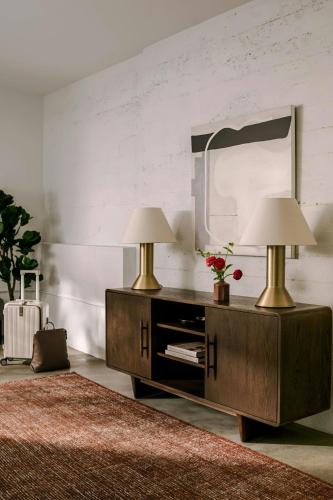 a bedroom with two lamps on a dresser with a mirror at Sonder by Marriott Bonvoy The Winfield Apartments Downtown LA in Los Angeles