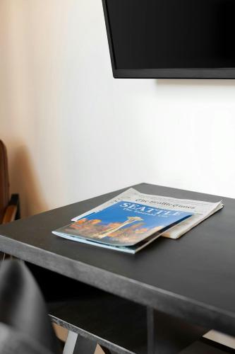 a table with a magazine on top of it at Sonder by Marriott Bonvoy RailSpur Apartments Pioneer Square in Seattle