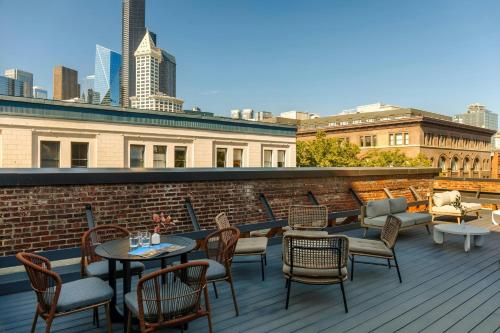 a patio with chairs and tables on a roof at Sonder by Marriott Bonvoy RailSpur Apartments Pioneer Square in Seattle