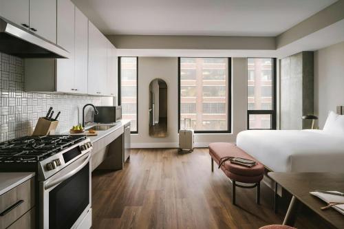 a kitchen and a bedroom with a bed in a room at Sonder by Marriott Bonvoy North Loop Green Apartments North Loop in Minneapolis