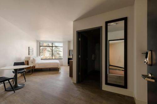 a room with a bedroom with a bed and a mirror at Sonder by Marriott Bonvoy Pivot Apartments Capitol Hill in Seattle