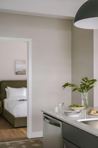 a kitchen with a sink and a bed in a room at Sonder by Marriott Bonvoy North Loop Green Apartments North Loop in Minneapolis