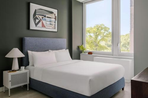 a bedroom with a large white bed and a window at Sonder by Marriott Bonvoy Battery Park Apartments Financial District in New York