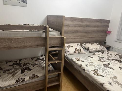 a bedroom with two bunk beds and a ladder at Apartman Omazić in Livno