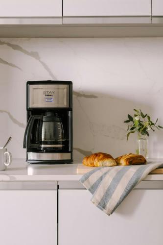 a microwave oven sitting on top of a counter with bread at Sonder by Marriott Bonvoy Battery Park Apartments Financial District in New York