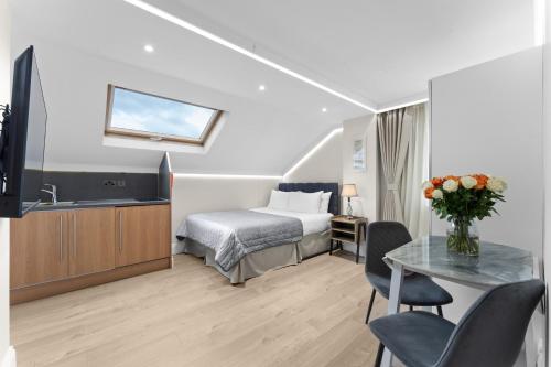 a hotel room with a bed and a table at Cleveland Residences Russell Square in London