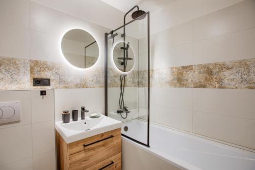 a bathroom with a sink and a shower at Hron River Apartment in Brezno
