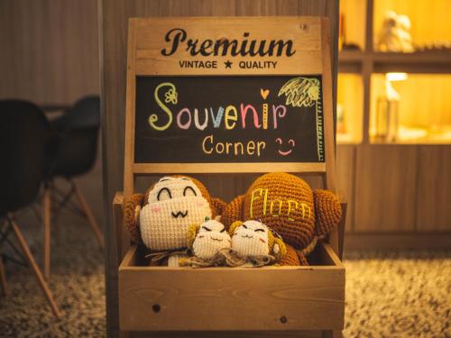 a wooden box with stuffed animals in front of a sign at Ploen Chaweng by Tolani in Chaweng
