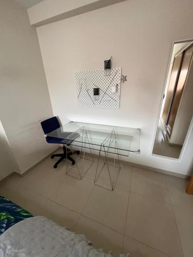 a glass table and a chair in a room at ÁTICO HOME y Garaje, Algemesi Home in Algemesí