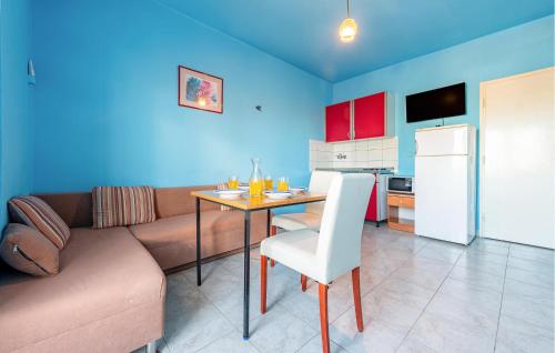 a living room with a couch and a table and a kitchen at Amazing Apartment In Povljana With Wifi in Povljana