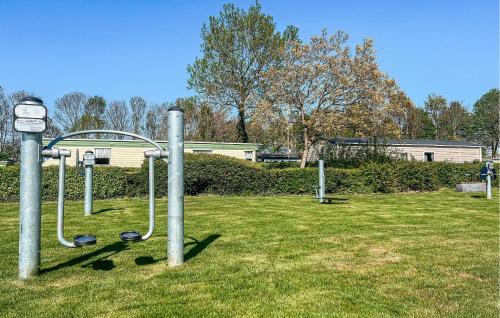a playground in a park with a grass field at Pet-Friendly Home In Scherpe Nisse in Scherpenisse