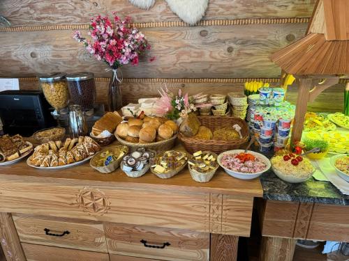 a buffet with many different types of food on a table at Witowianka in Witów