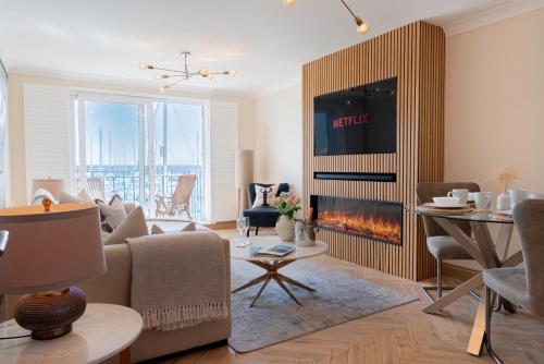a living room with a couch and a fireplace at Stunning modern space with harbour views & free parking in Brighton & Hove