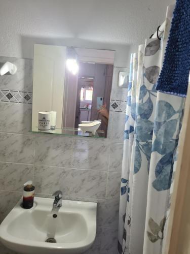 a bathroom with a sink and a mirror at SPITIKARIOTIKO Garden home in Mesochórion