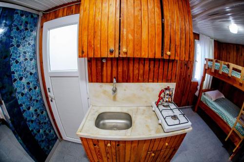 a small bathroom with a sink and a stove at Devrim Apart in Ocaklar