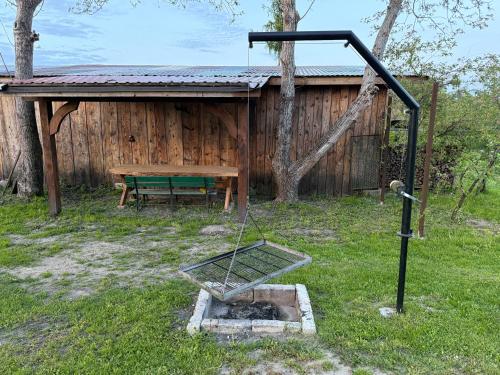 a picnic table and a swing in front of a building at Pokoje Gościnne Pod Szyszkami in AdamÃ³w