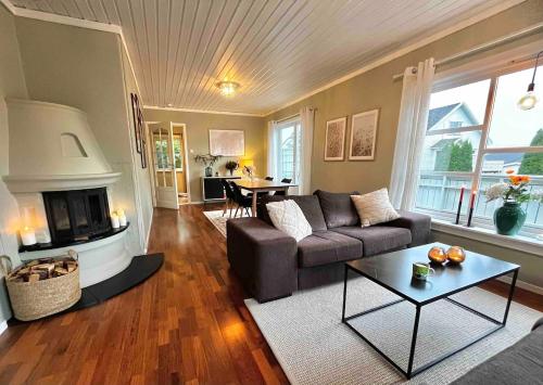 a living room with a couch and a fireplace at Anchor Point Farsund in Farsund