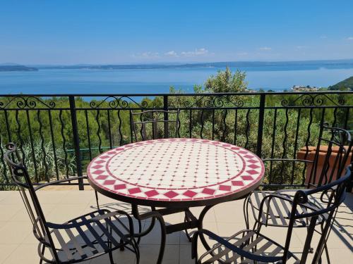 a table and chairs on a balcony with a view of the water at Appart'hotel Résidence La Provence in Istres