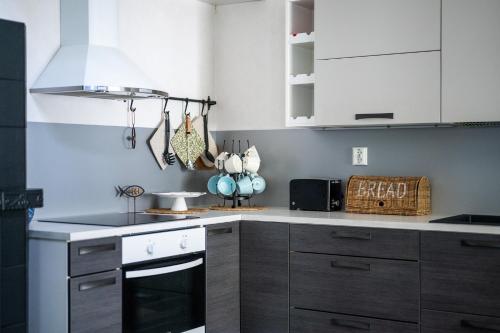 a kitchen with white cabinets and a stove top oven at Holiday Villa Kallan Pore in Kalajoki