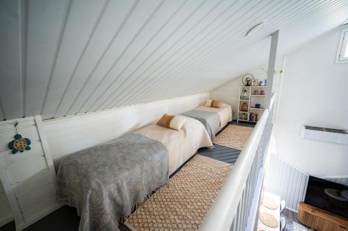 a bedroom with two beds in a attic at Holiday Villa Kallan Pore in Kalajoki