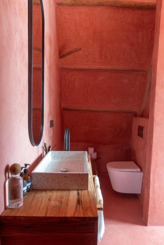 a bathroom with a sink and a toilet at Be Zanzibar Boutique Hotel in Mfumbwi