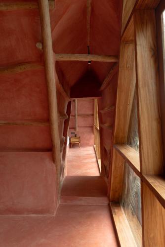 an attic hallway in a house with wooden ceilings at Be Zanzibar Boutique Hotel in Mfumbwi