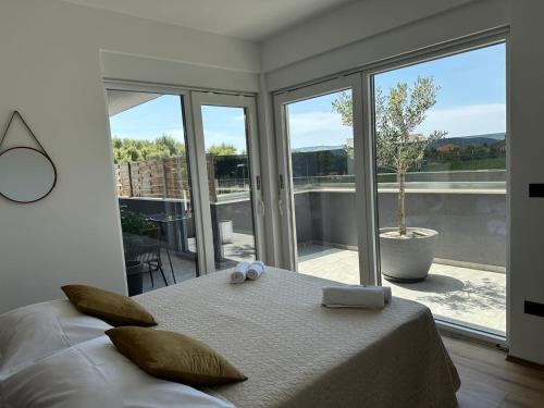 a bedroom with a bed and a large window at Villa Helena in Trogir