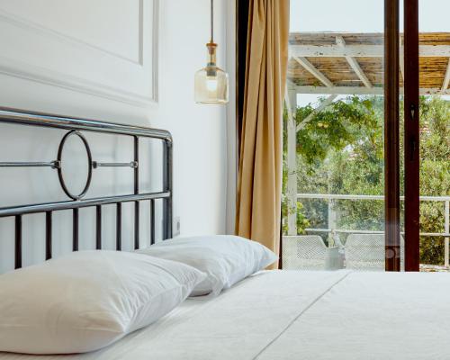 a bedroom with a bed with a view of a window at Sea Garden Kaş Hotel in Kas