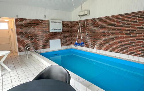 a swimming pool in a room with at Cozy Home In Fårevejle in Fårevejle