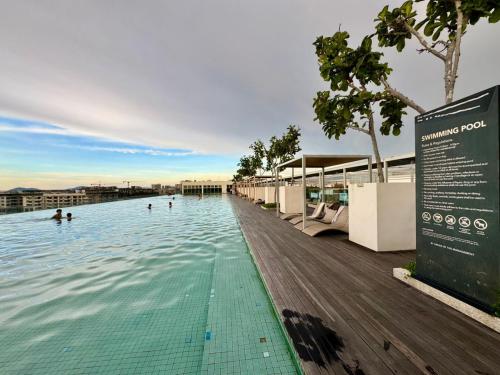 a swimming pool with people in the water at SA Sutera Avenue Homestay Opposite Imago KK in Kota Kinabalu