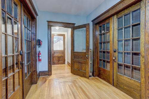 an empty hallway with wooden doors and wooden floors at The Kinley House in Lunenburg