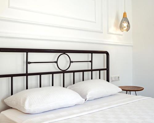a bed with a black headboard and a table at Sea Garden Kaş Hotel in Kas