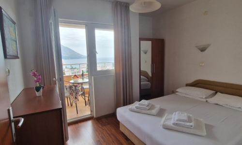 a bedroom with a bed with two towels on it at Evropa Lux Apartments in Budva