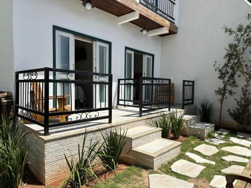 a porch of a house with stairs and a balcony at Pousada Maria Monteiro Tiradentes in Tiradentes