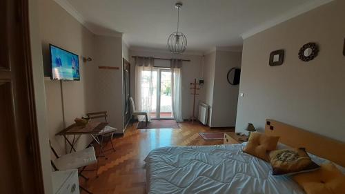 a bedroom with a bed and a living room at Morada do Ultramar in Viana do Castelo