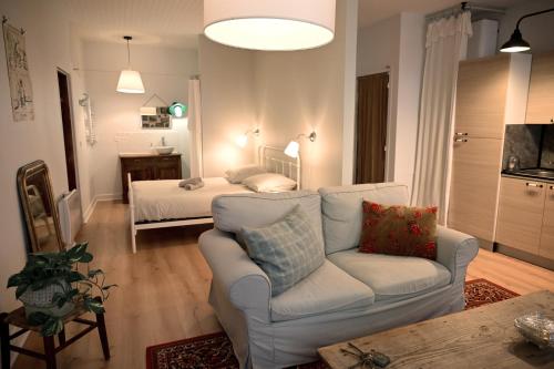 a living room with a couch and a bed at La Brocante - Meilleurhote-Brioude in Brioude