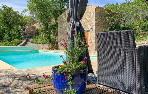 a patio with an umbrella and a swimming pool at Maison Vue Panoramique in Plaisians