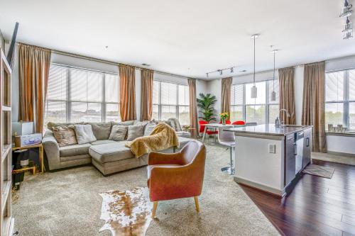 a living room with a couch and a table at Luxury Downtown Crown Apartment in Gaithersburg