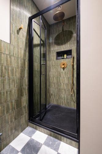 a shower with a glass door in a bathroom at Hanley House in Tenbury