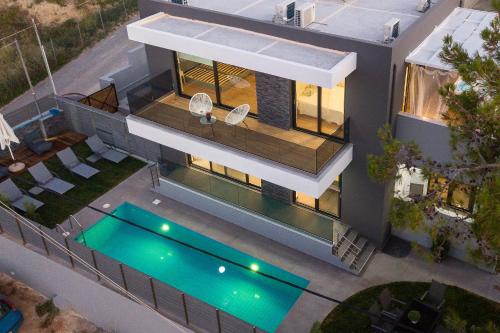 an aerial view of a house with a swimming pool at Nisos Villa, Pool & Heated SpaWhirlpool, Walking to Beach, By ThinkVilla in Sfakaki