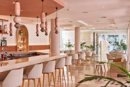 a bar in a restaurant with stools at Zafiro Alzinar Mar Adults Only - Refurbished 2025 in Can Picafort