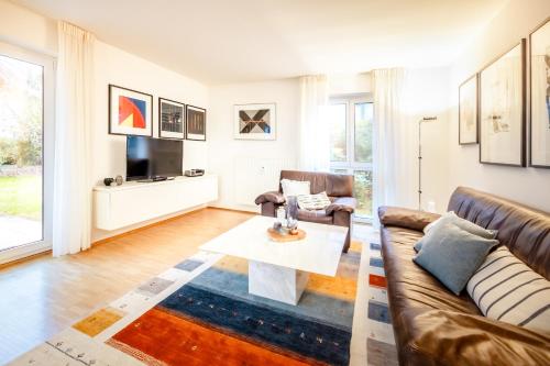 a living room with a couch and a table at Haubentaucher in Hemmenhofen