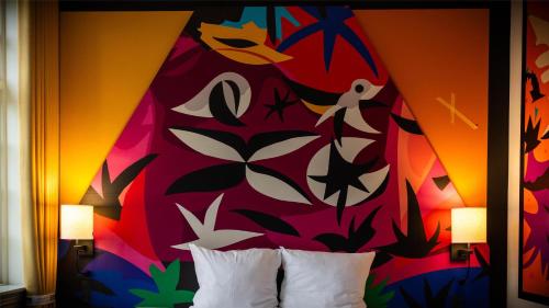 a colorful bedroom with a bed with two pillows at ART Hotel Dalgas, BW Signature Collection in Brande